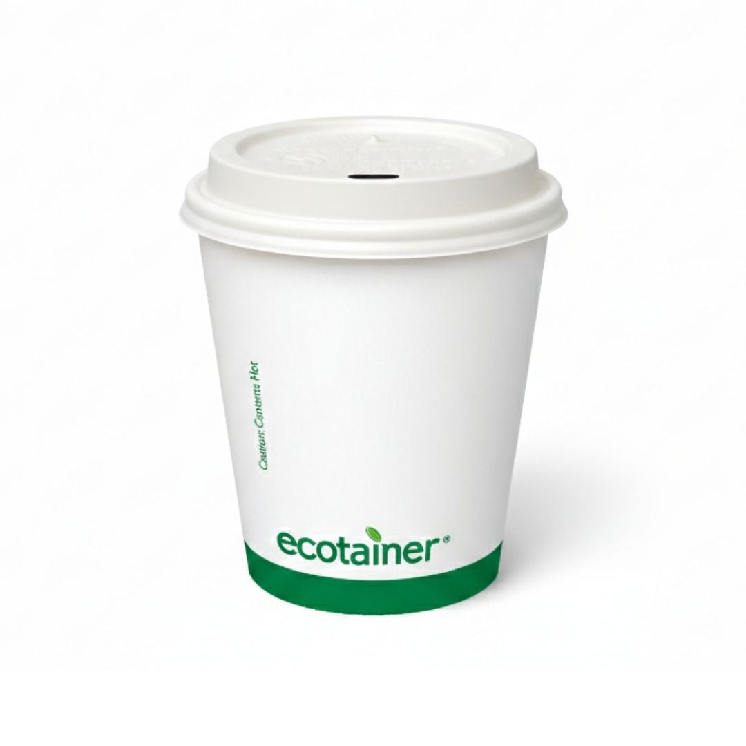 White paper cup with a green logo and a white hot cup lid on a white background