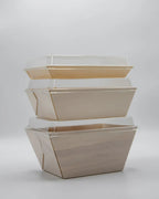 Set of four beige nesting food boxes on a light gray background