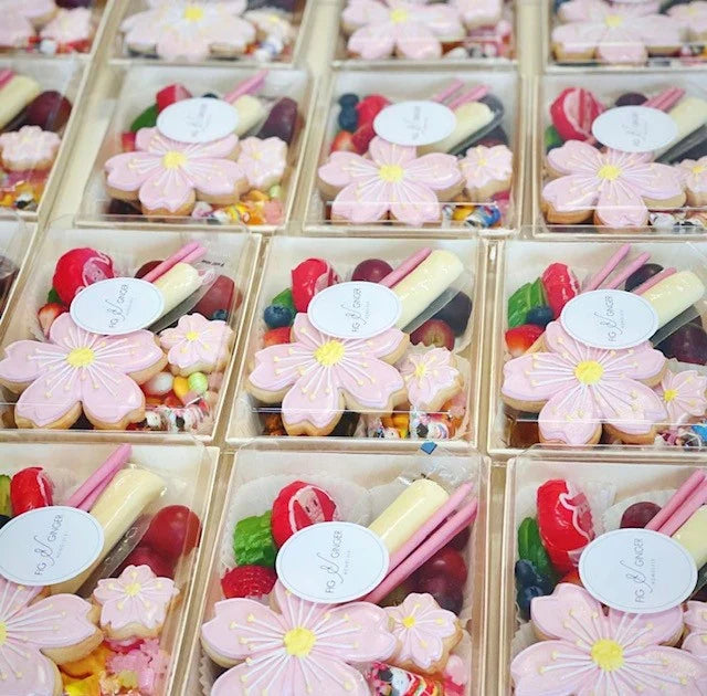 Boxes of assorted candies with flower-shaped cookies on top