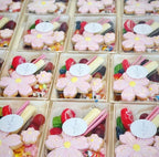 Boxes of assorted candies with flower-shaped cookies on top