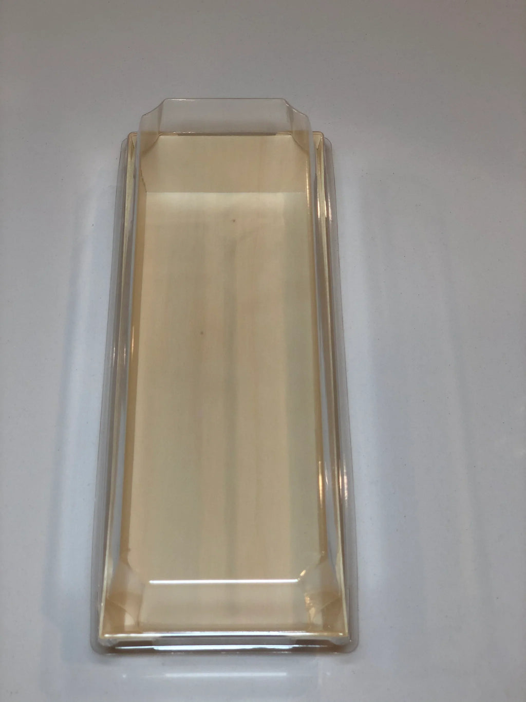 Compostable wood tray with clear lid on a plain background