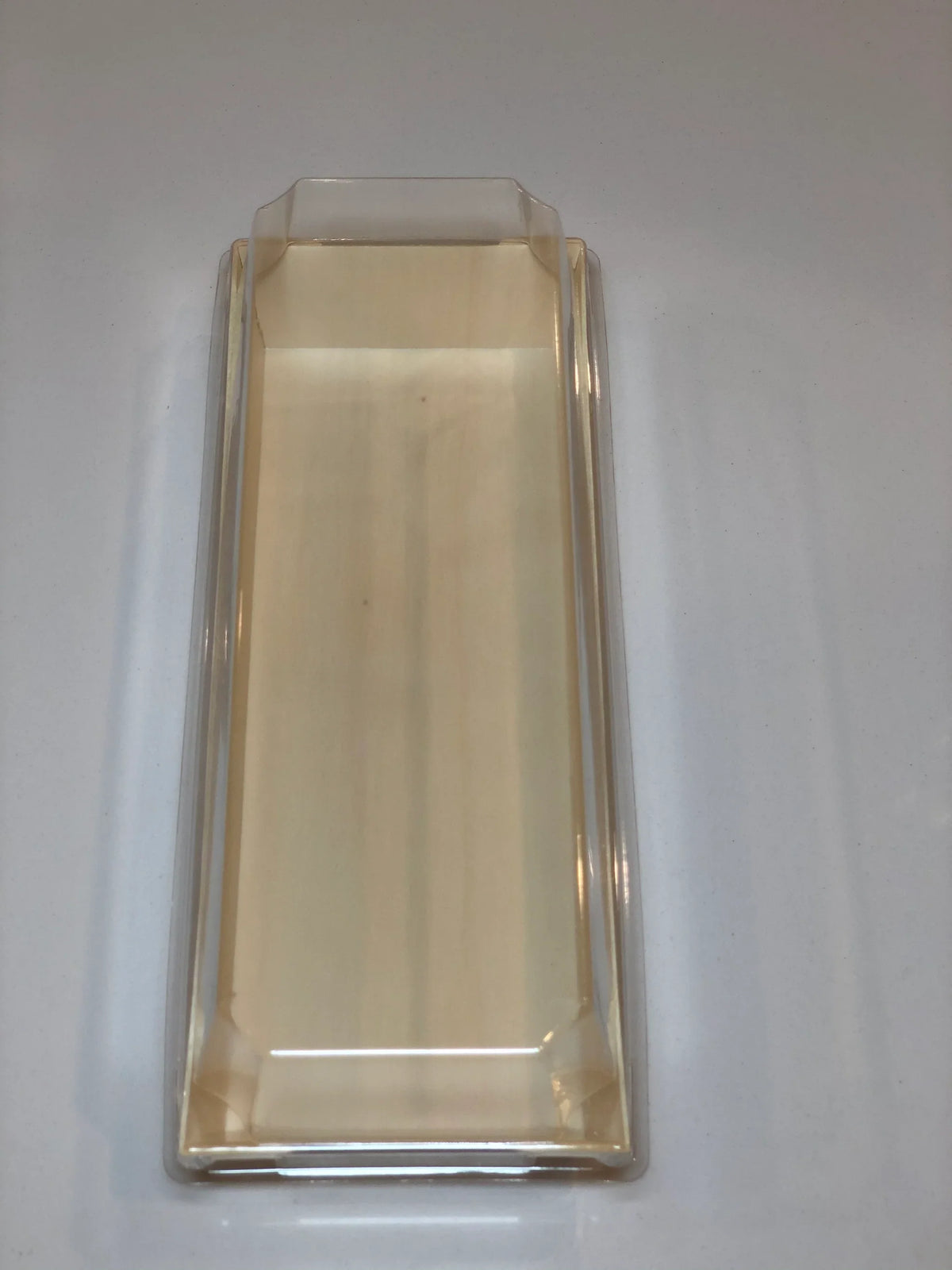 Compostable wood tray with clear lid on a plain background