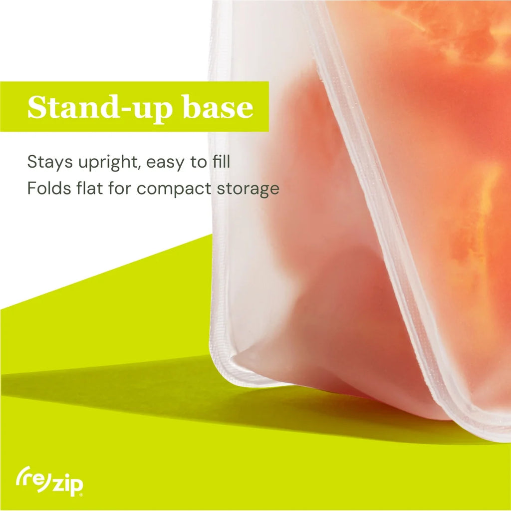 Transparent silicone container with food on a green background, featuring text about the stand-up base.