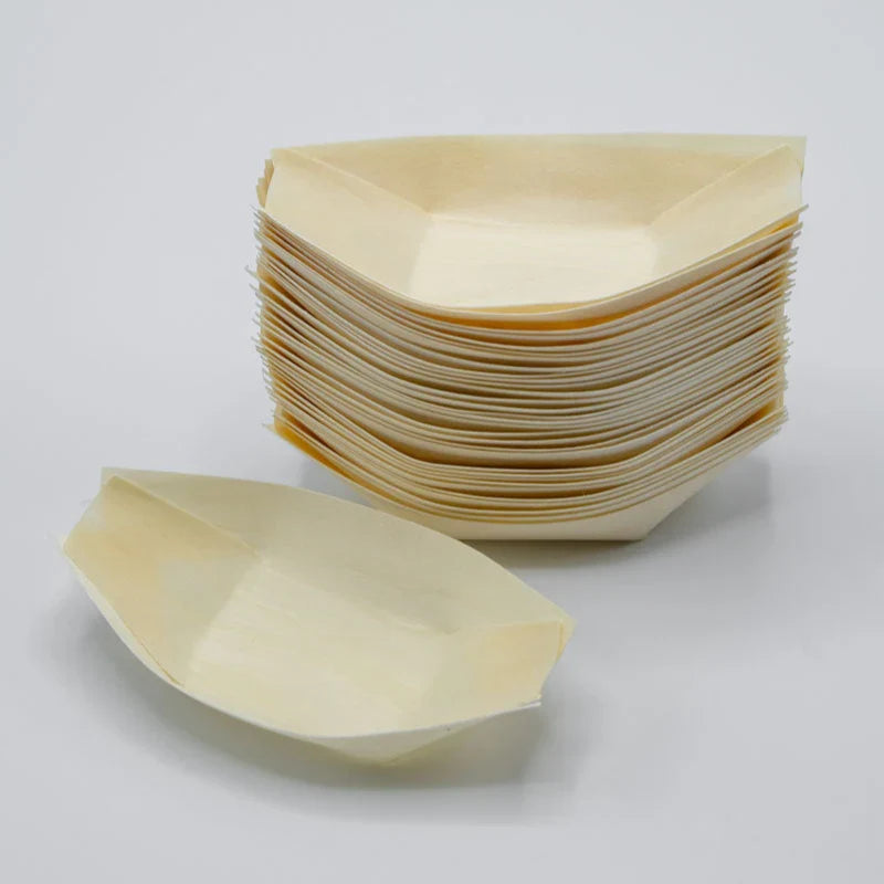 Stack of disposable leaf-shaped plates on a light gray background