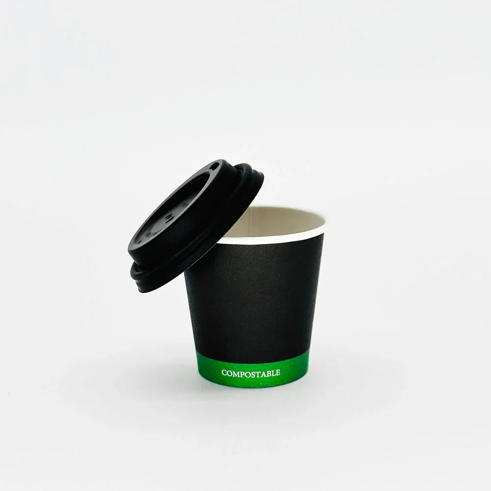 Black compostable cup with a lid on a white background