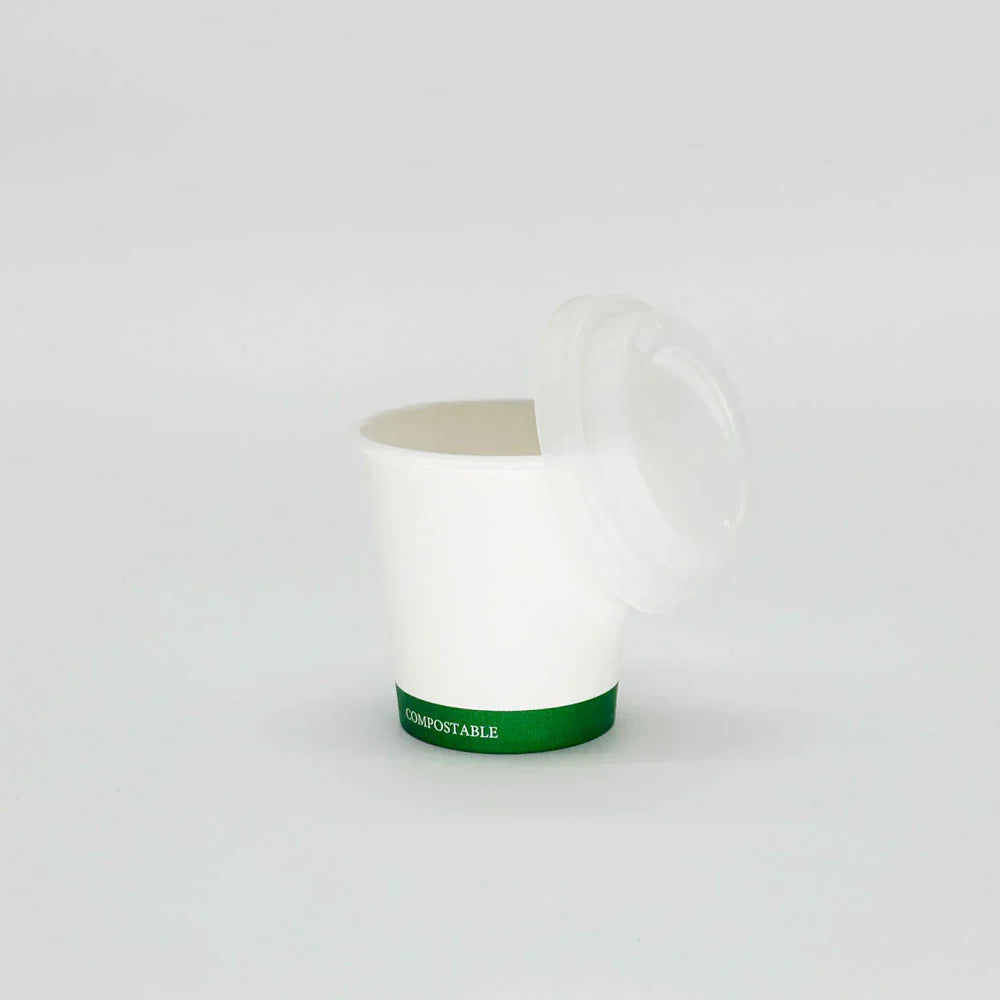 White compostable cup with a lid on a white background