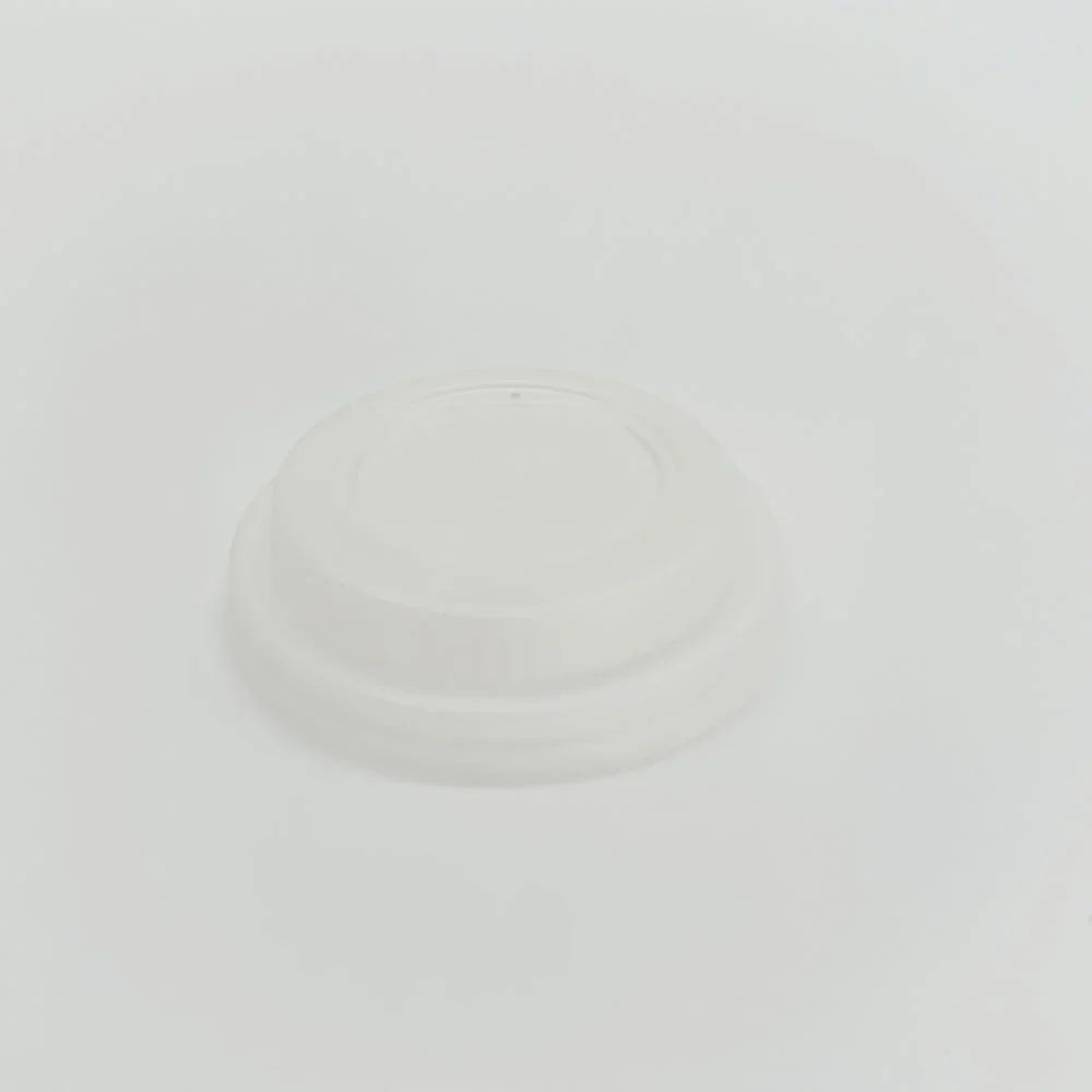 Plain white disposable lid on a light gray background