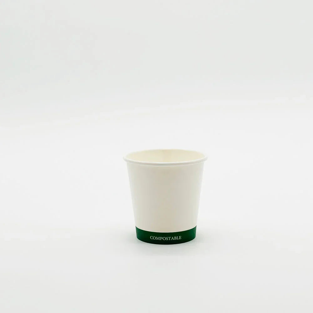 Compostable hot cup with green rim on a white background