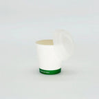 Green label hot cup with a lid on a white background
