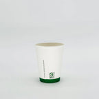 White cup with green rim and BPI logo on a light gray background