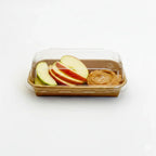 Rectangular container with lid containing sliced apples with peanut butter on a white background