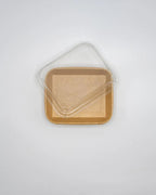 Clear plastic lid on a kraft tray against a white background