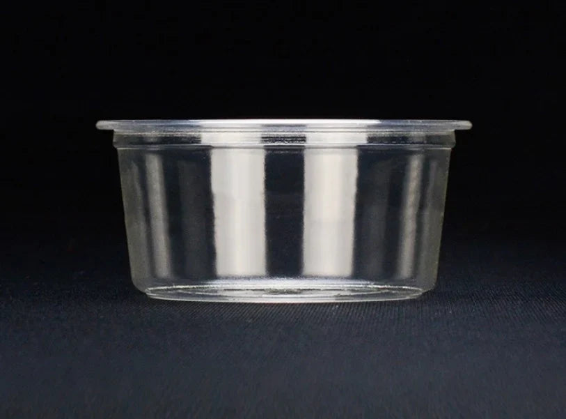 Clear portion cup on a black background