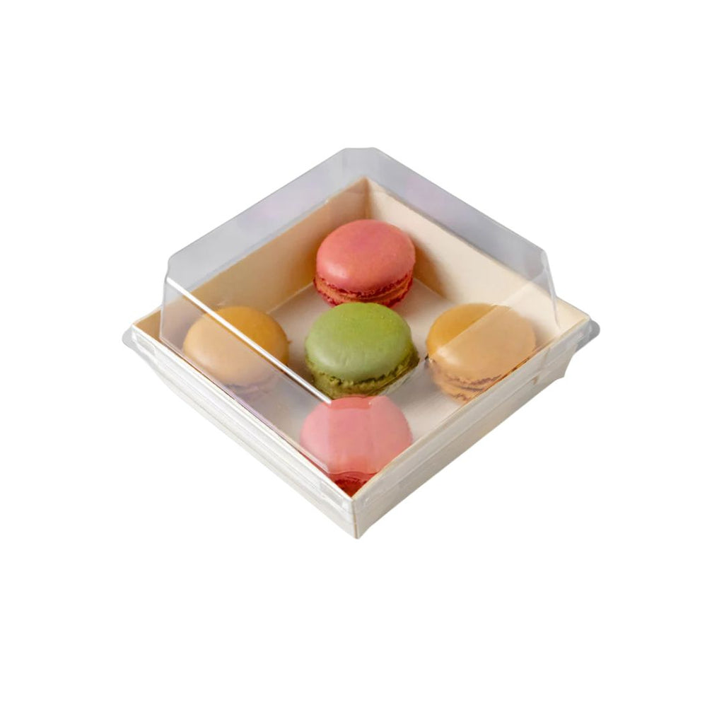 Box of colorful macarons on a white background