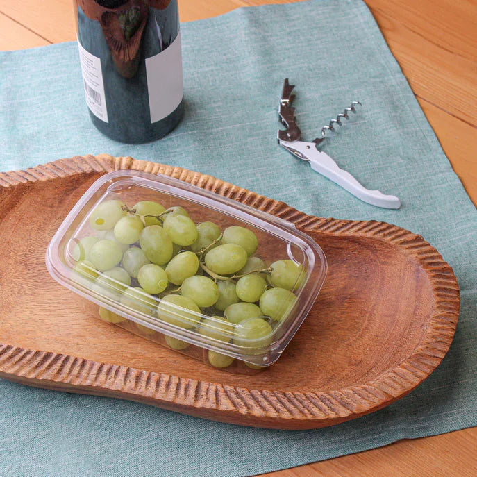 Clear produce clamshell filled with grapes on a tray.