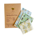 Plant-Based Wax Wraps stands next to three reusable cloth wraps with avocado and blueberry patterns on a white background.