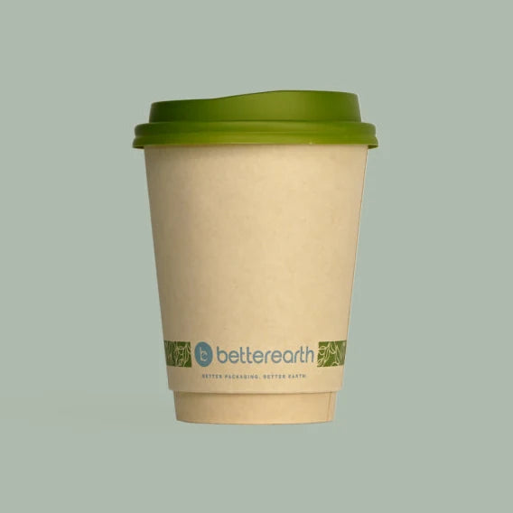 Compostable coffee cup with compostable green lid on a light gray background