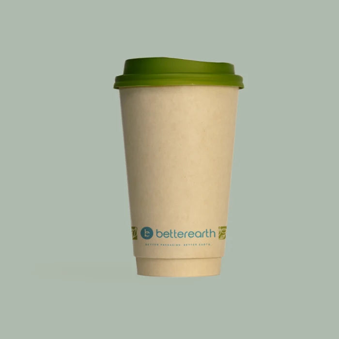 Compostable coffee cup with green lid on a light gray background