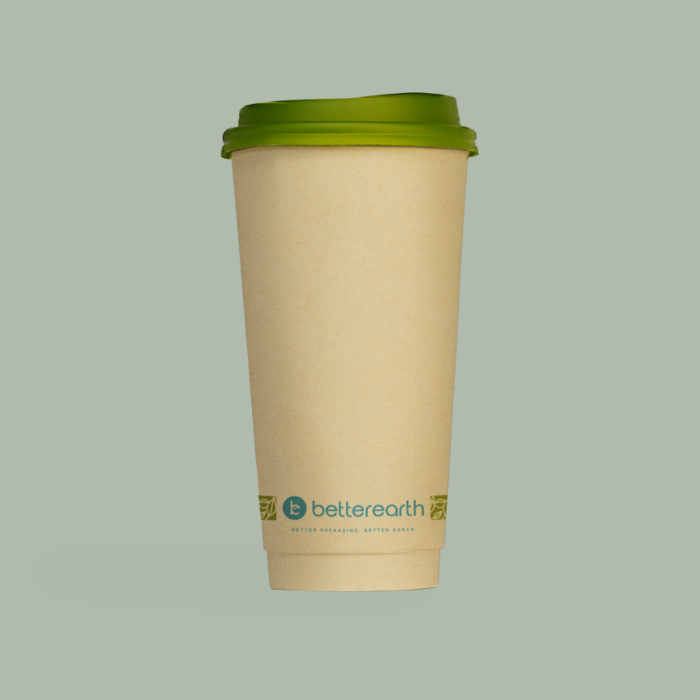 Compostable coffee cup with green lid on a light gray background