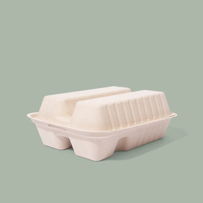 Closed compostable taco clamshell on a light green background