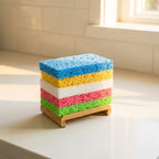 Colorful sponges stacked on a wooden stand in a kitchen setting
