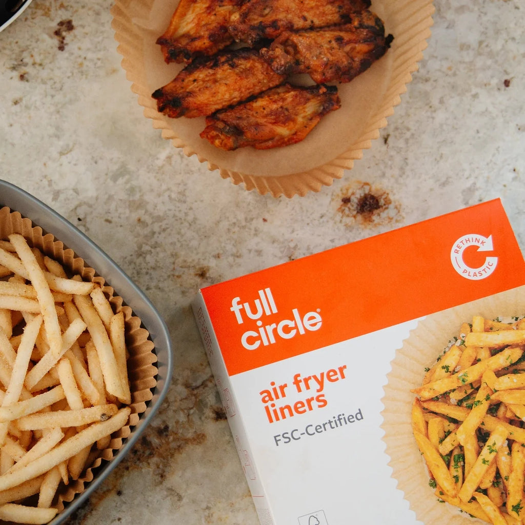 Box of full circle air fryer liners with air fried food on a countertop