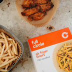 Box of full circle air fryer liners with air fried food on a countertop