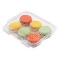 Clear box of 6 colorful macarons on a white background