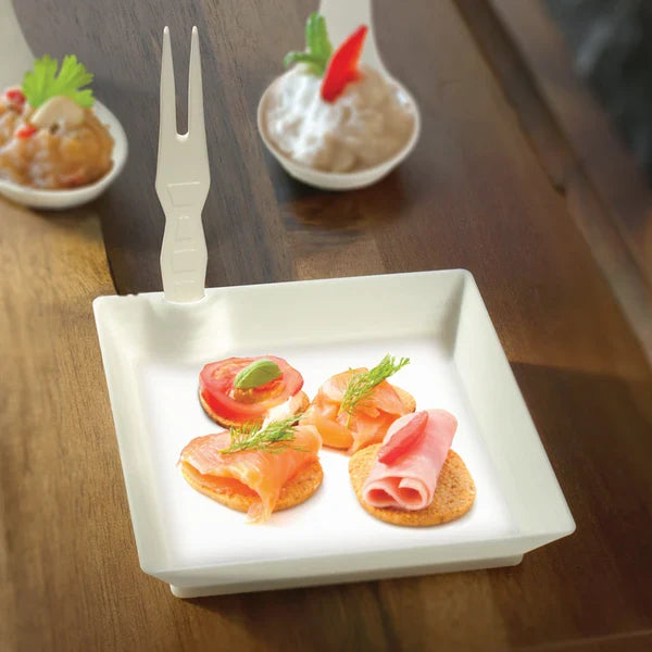 Small appetizer plate with appetizers on a wooden table